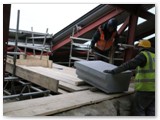 06 The heavy coping stone is moved using the ancient Egyptian system of rollers on wooden planks