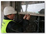 01 Putty is applied to the storm-glazing frame before the window is inserted