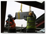 04 A new coping stone is guided in through the opening on the temporary roof on the east side of the Cathedral
