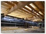 05 The flat section of the ceiling below with the sloped wood of the roof above which will be covered and slated