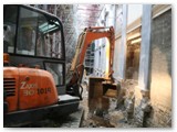 05 This is then scooped up by a digger that reaches down from ground level to scoop it up out of the crypt