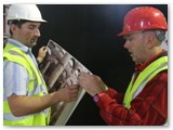 06 Ronan Moore and Gerry Reilly putting up photos of the damage immediately after the fire