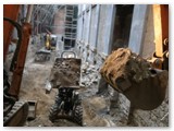 06 The digger at ground level places the debris into another dumper