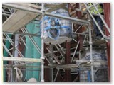 07 The section of pillar is positioned above a trolley on the ground