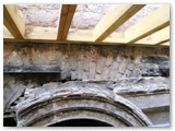 07 The wooden planks of the ceiling over the west aisle just above a pillar arch looking into the main nave