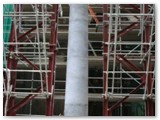 08 A newly installed pillar with protective covers over the base and capital stone