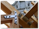 08 A truss and roof beams in position on the side aisle close to the bell-tower