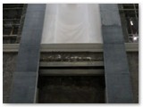 20 East wall - a statue niche, two pilasters either side, and arch plasterwork above two stained-glass window niches complete