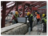 10 Another coping stone is rolled into position while a further one has arrived in the background