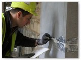 12 Applying mortar to the joins between the pilaster slabs
