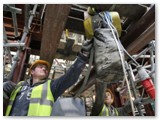 12 The hoist is moved back into position for the last piece - the capital stone