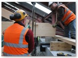 40 The truss is lowered by the hoist into the niche in the coping stone